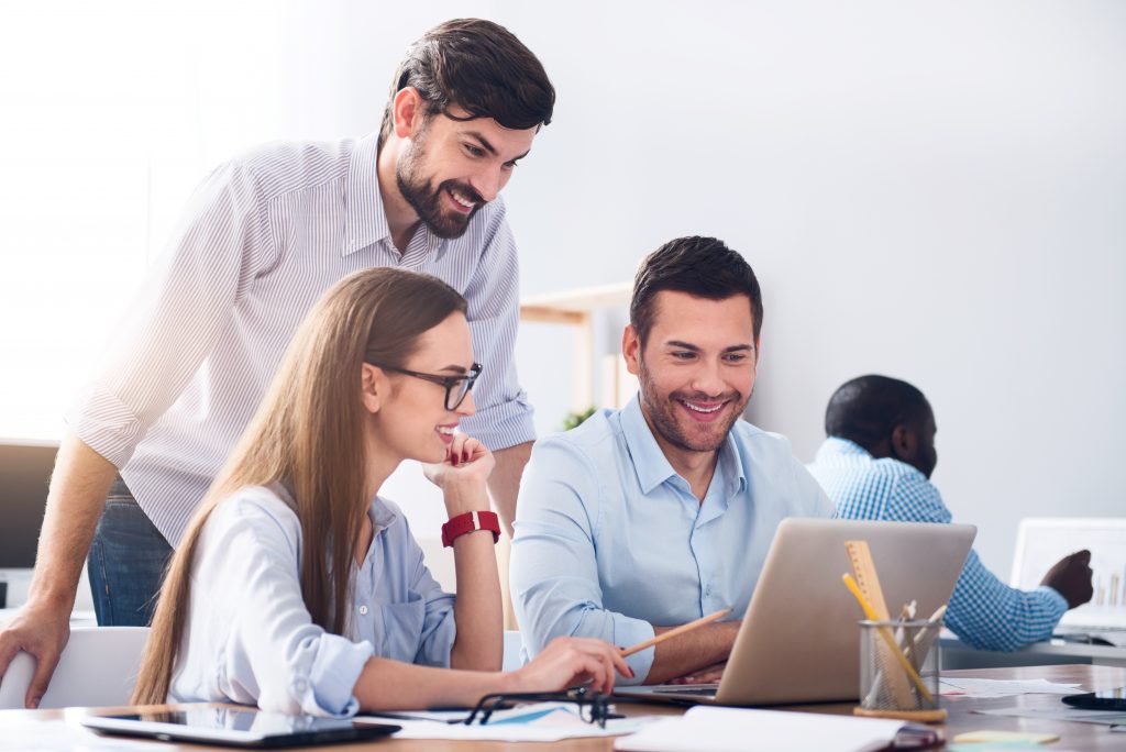 Pleasant Smiling Colleagues Discussing Project Outlook Troubleshooting
